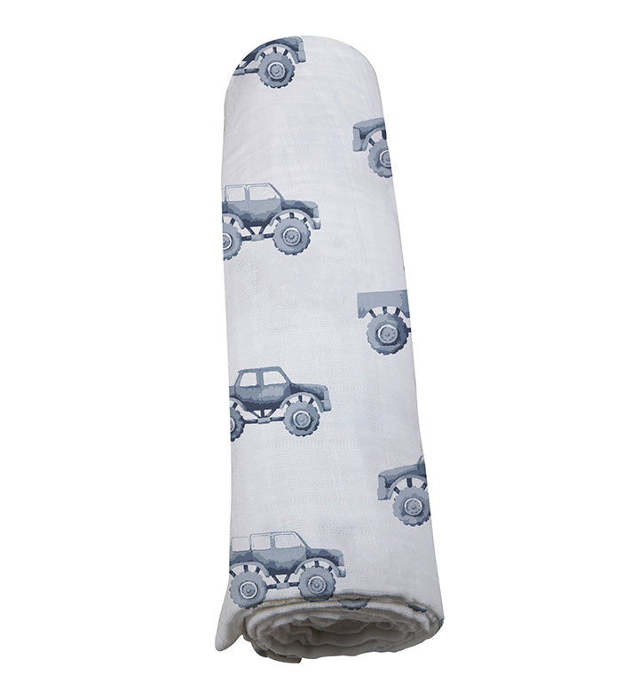 Indigo Monster Trucks Cotton Swaddle featuring playful truck designs on soft muslin fabric, perfect for swaddling and versatile baby care.