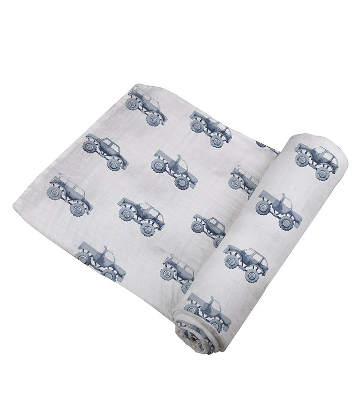 Indigo Monster Trucks Cotton Swaddle featuring playful truck designs on soft muslin fabric, perfect for swaddling and versatile baby care.