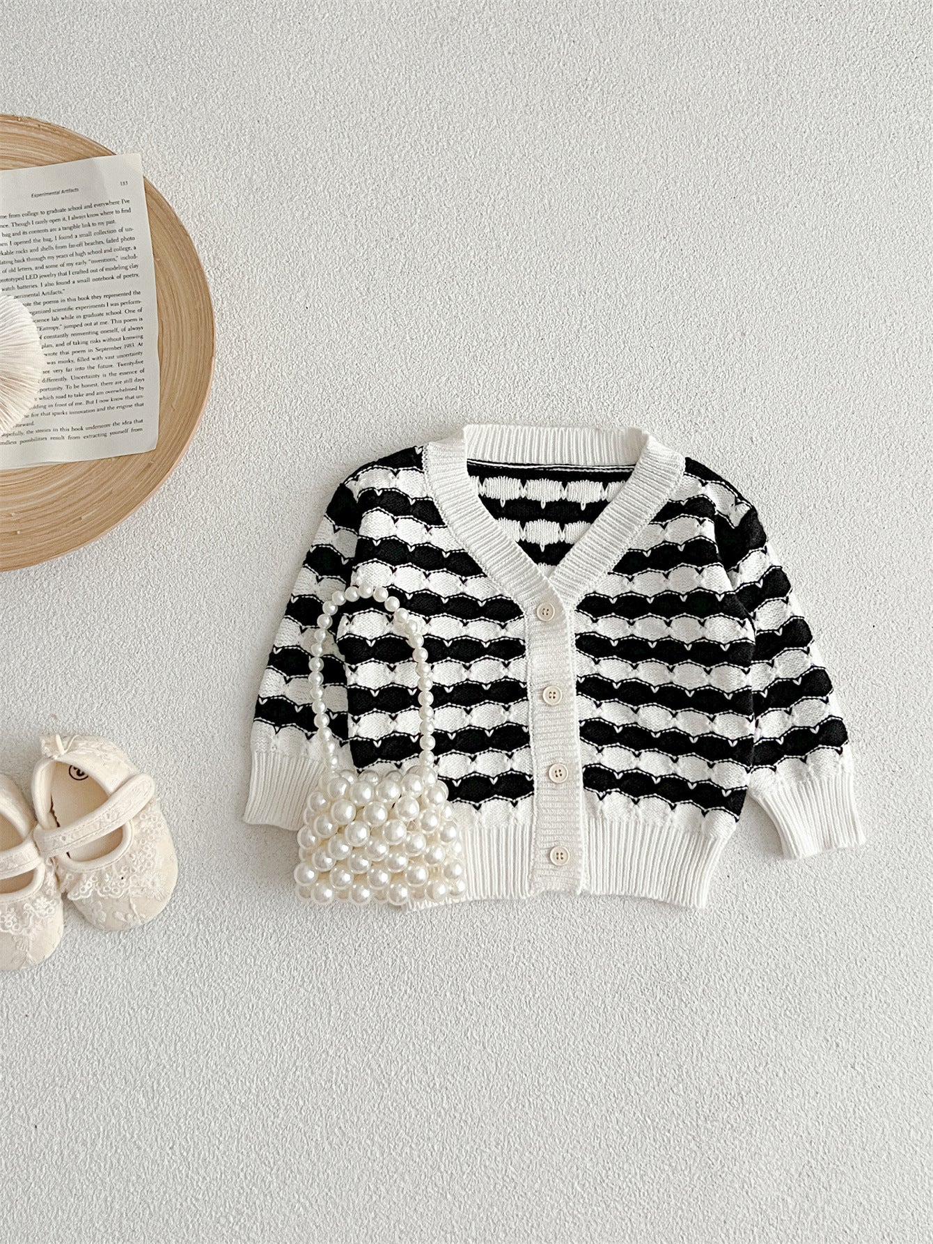 Infant baby boys and girls striped long-sleeved cardigan in black and pink colors, made of soft cotton material.