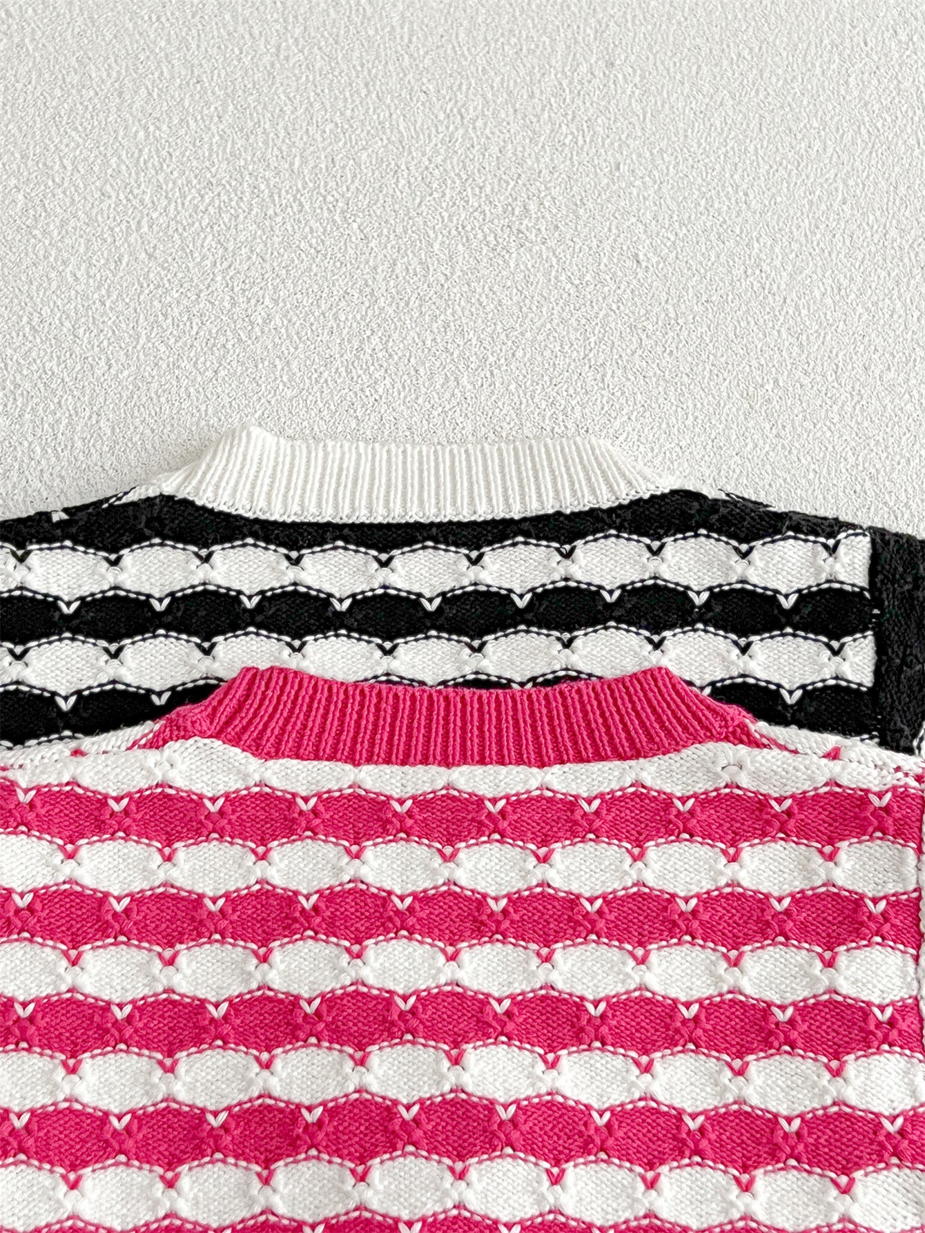 Infant baby boys and girls striped long-sleeved cardigan in black and pink colors, made of soft cotton material.