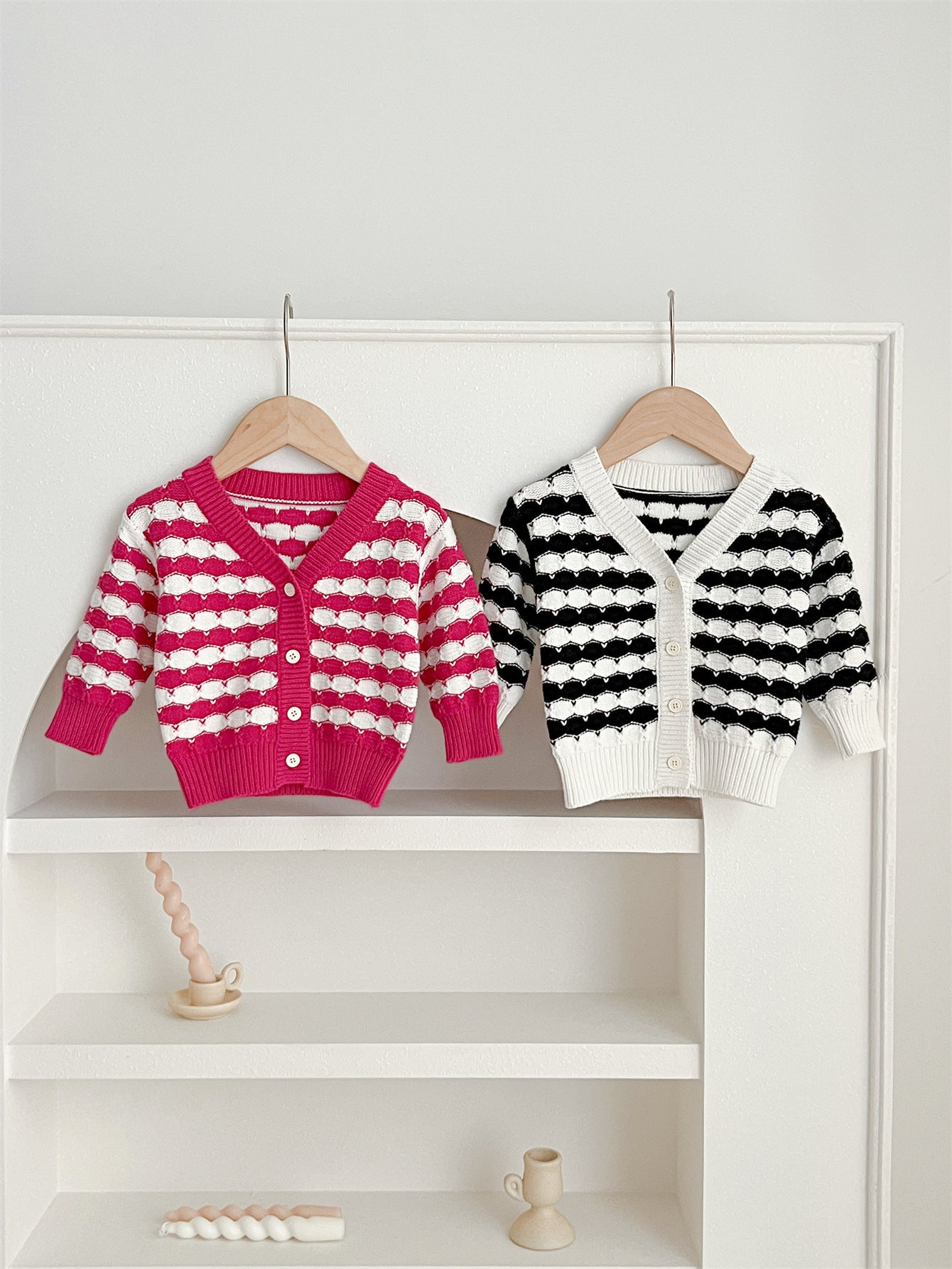 Infant baby boys and girls striped long-sleeved cardigan in black and pink colors, made of soft cotton material.