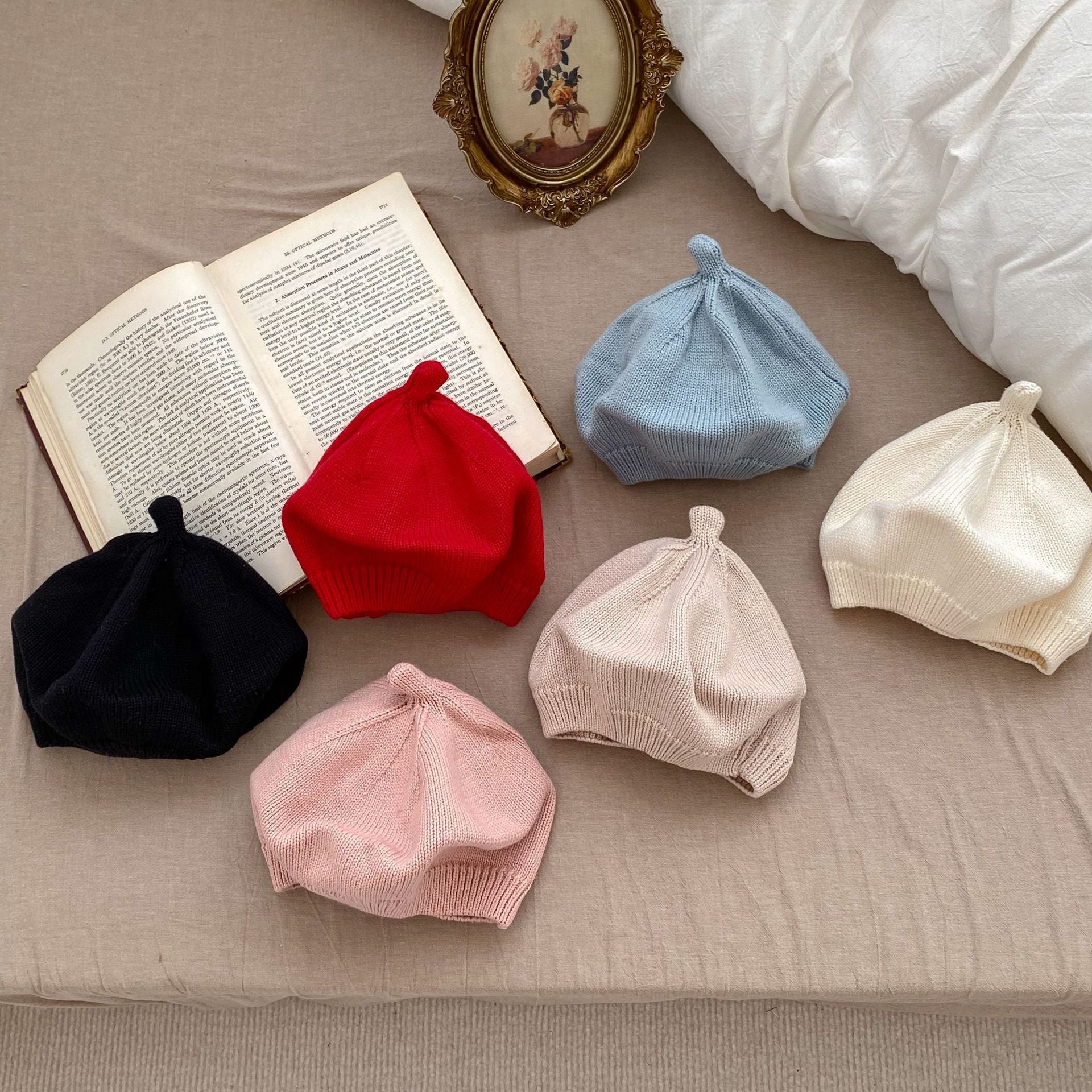 Infant baby girls solid knitting caps in various colors including white, black, red, pink, light blue, and beige, made from soft cotton material.