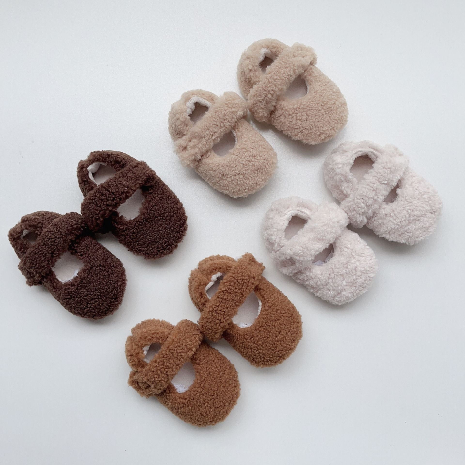 Infant baby solid color plush warm shoes in white, apricot, brown, and coffee, perfect for winter wear.