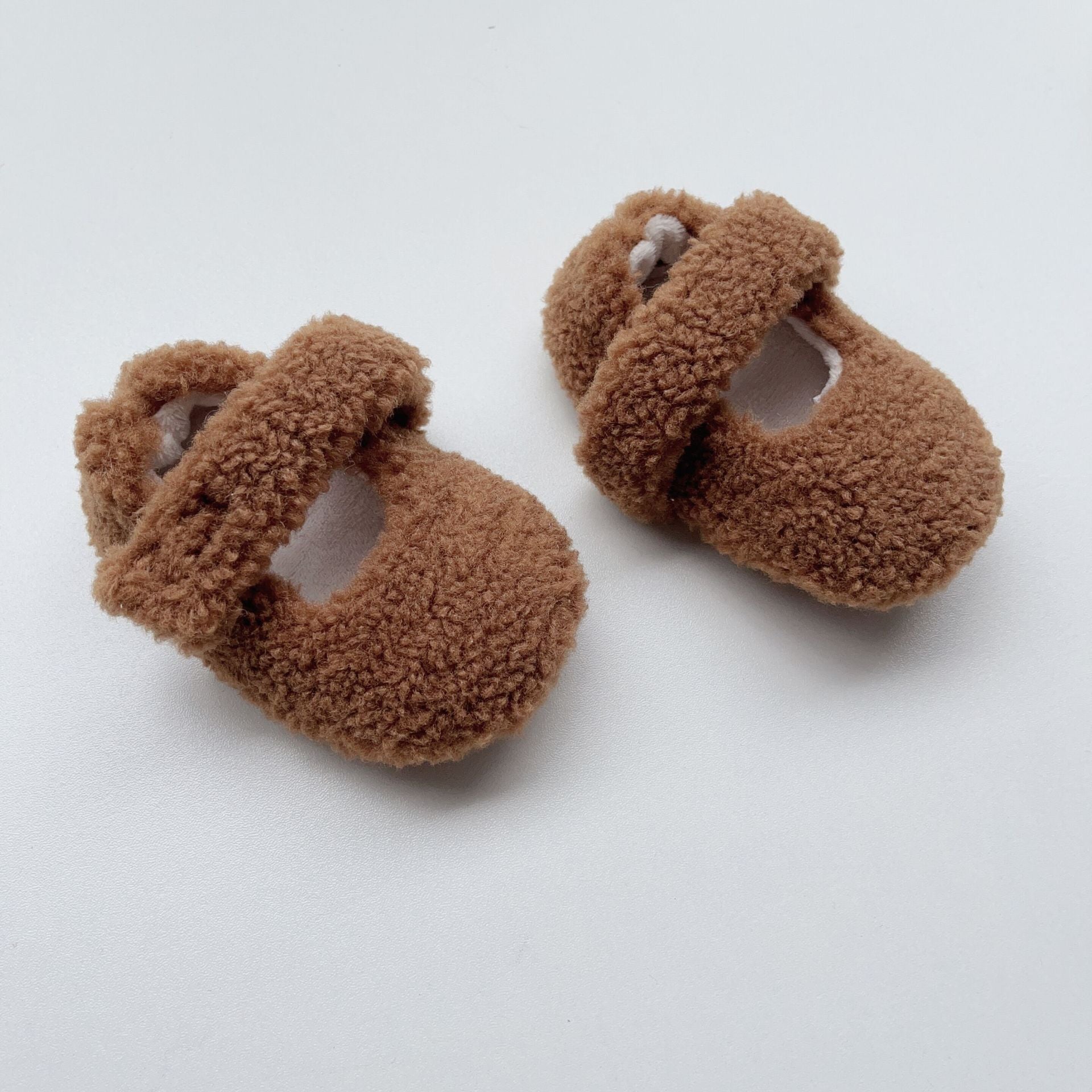 Infant baby solid color plush warm shoes in white, apricot, brown, and coffee, perfect for winter wear.