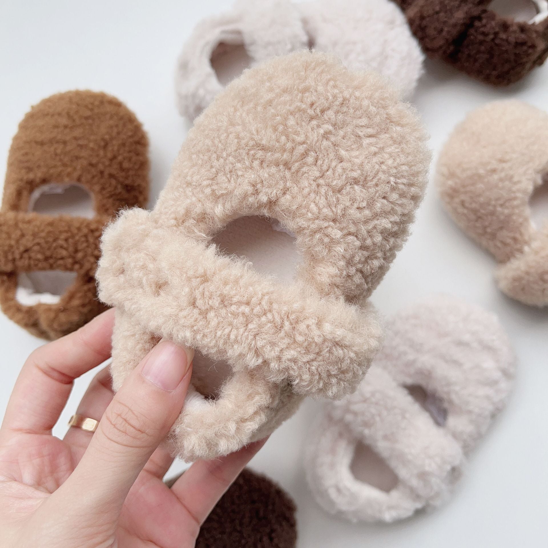 Infant baby solid color plush warm shoes in white, apricot, brown, and coffee, perfect for winter wear.