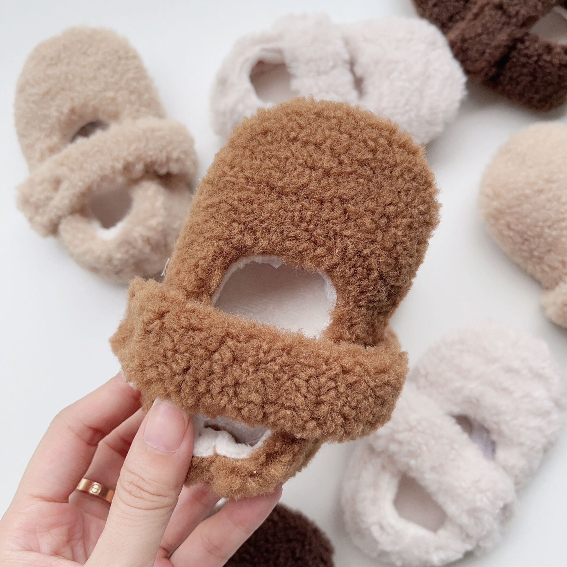 Infant baby solid color plush warm shoes in white, apricot, brown, and coffee, perfect for winter wear.