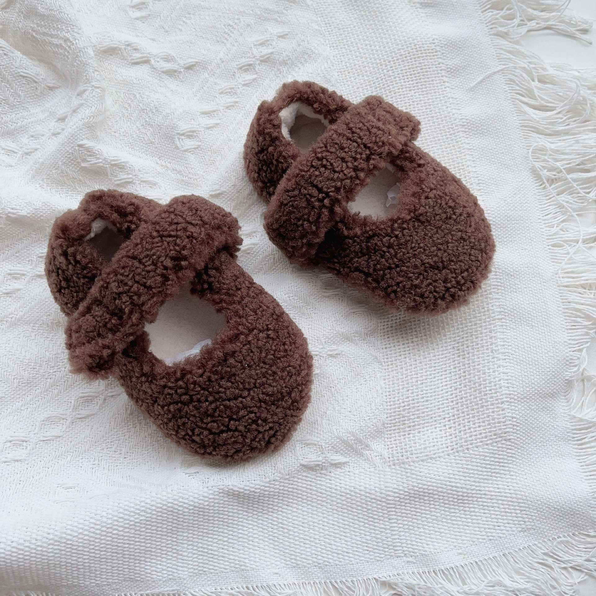 Infant baby solid color plush warm shoes in white, apricot, brown, and coffee, perfect for winter wear.