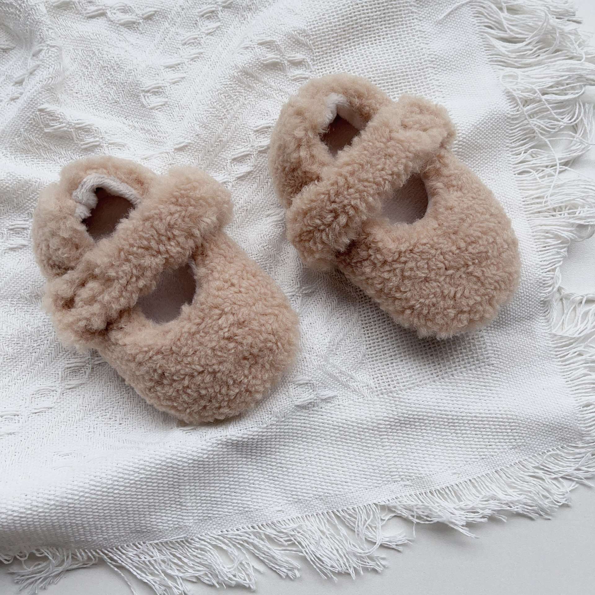 Infant baby solid color plush warm shoes in white, apricot, brown, and coffee, perfect for winter wear.