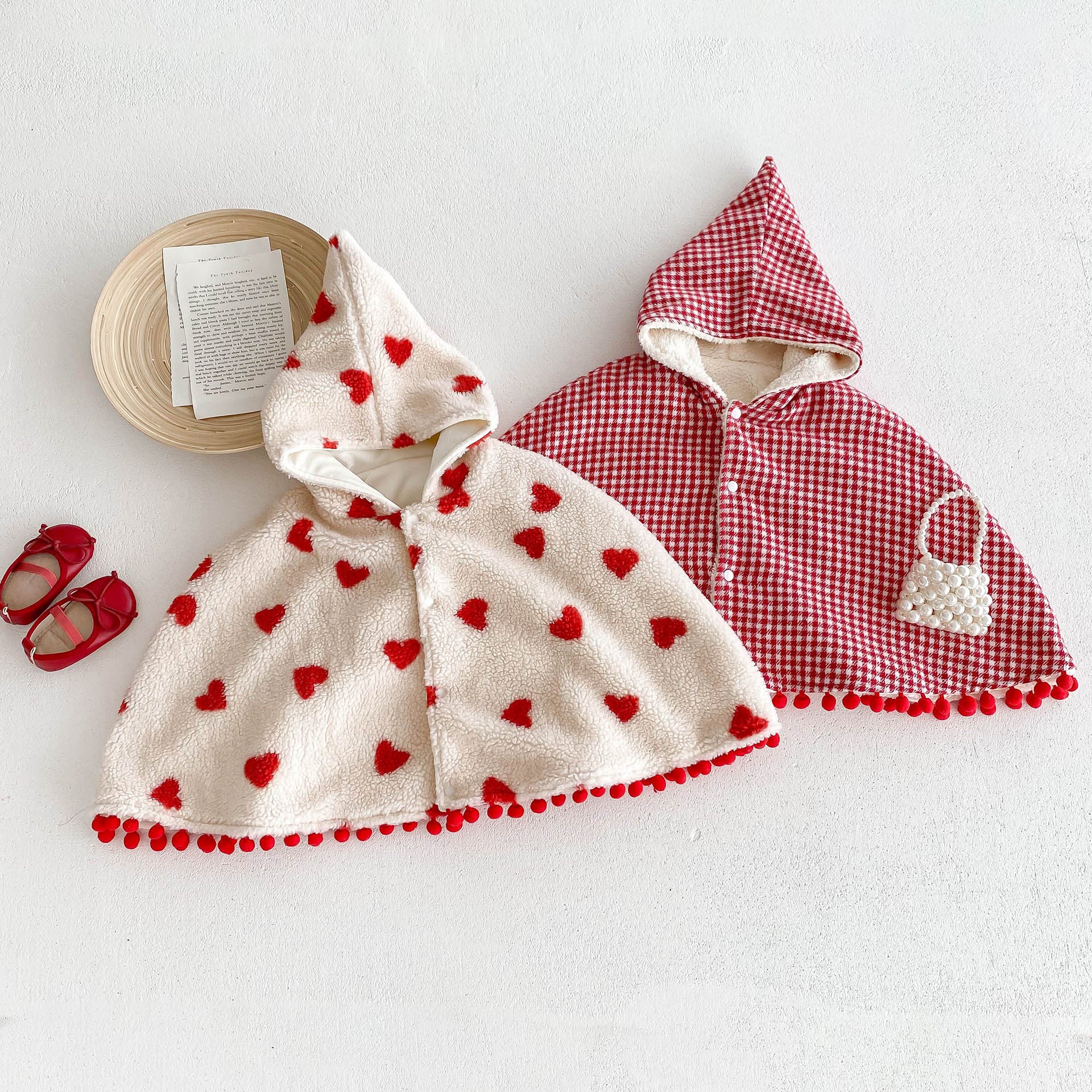 A cozy thick warm cloak for baby girls in red and apricot colors, featuring plaid and heart patterns, perfect for winter wear.