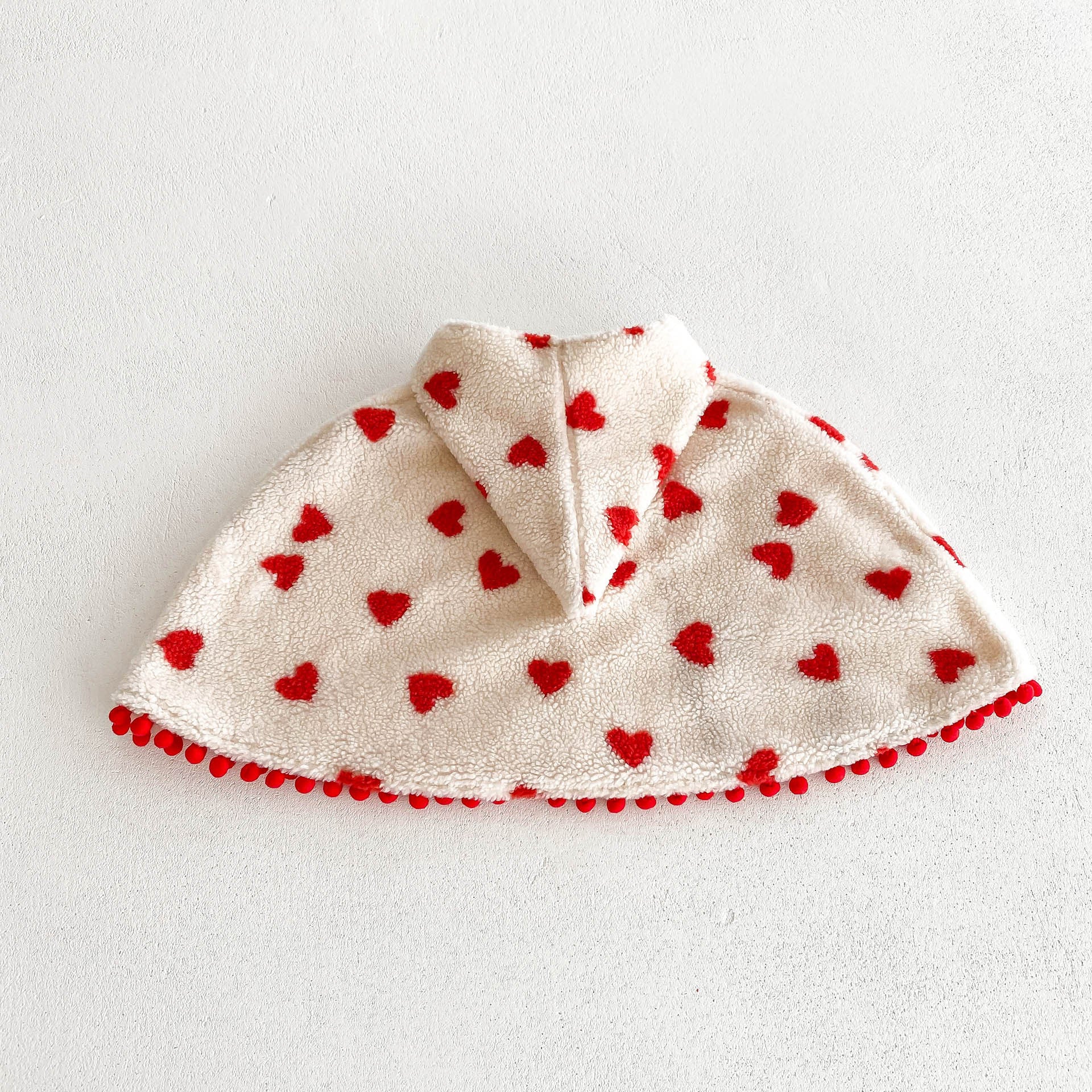 A cozy thick warm cloak for baby girls in red and apricot colors, featuring plaid and heart patterns, perfect for winter wear.