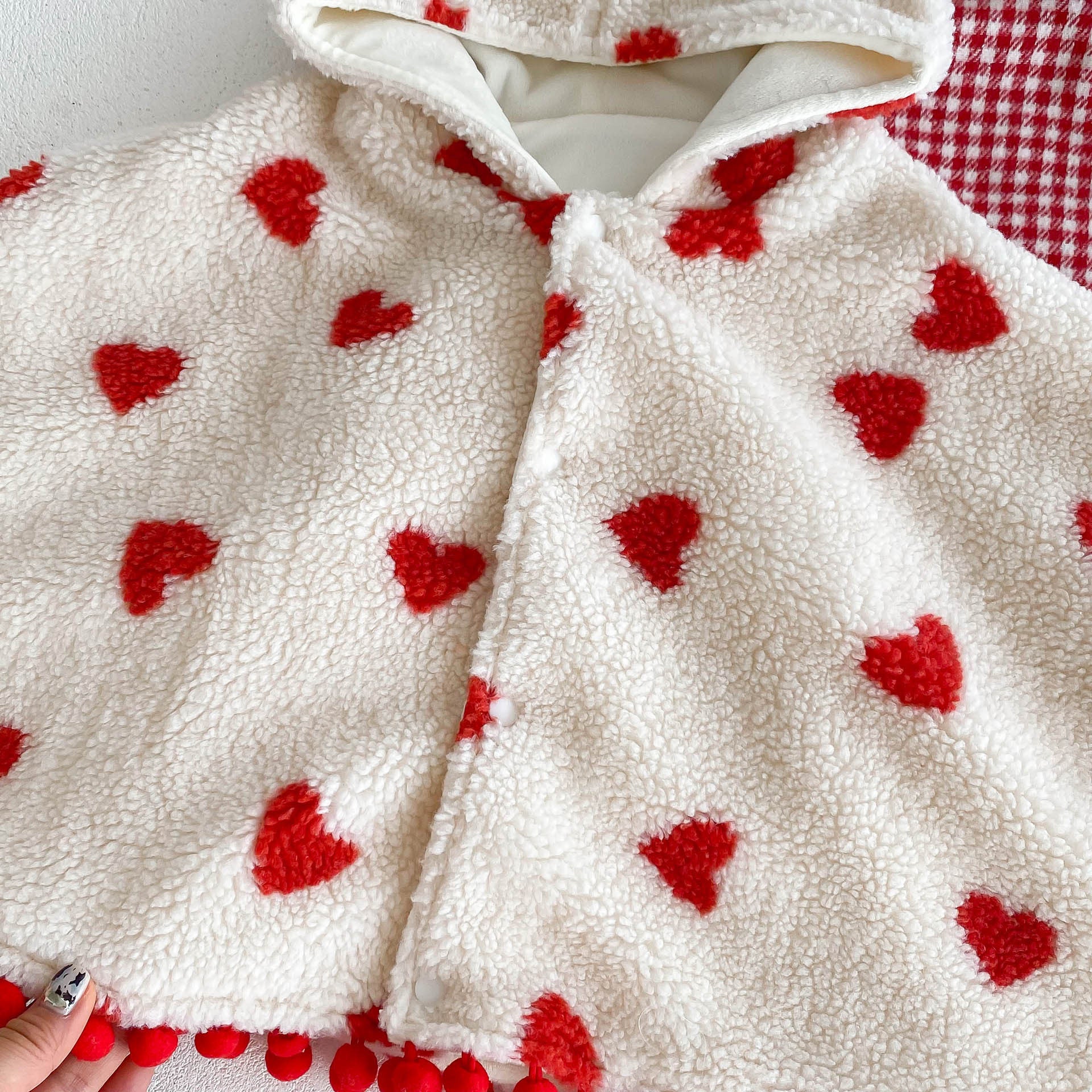 A cozy thick warm cloak for baby girls in red and apricot colors, featuring plaid and heart patterns, perfect for winter wear.