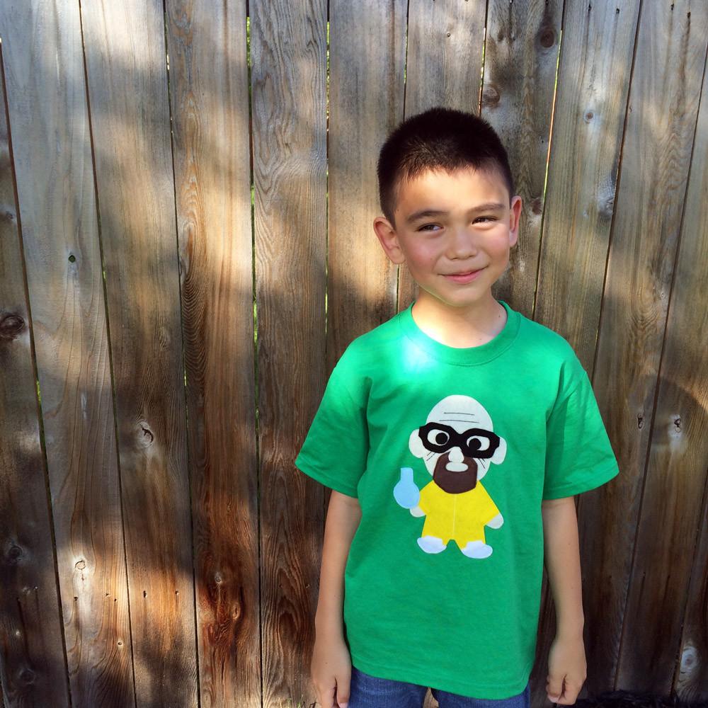 A vibrant green Kids T-shirt featuring a playful cooking design, perfect for little chefs.