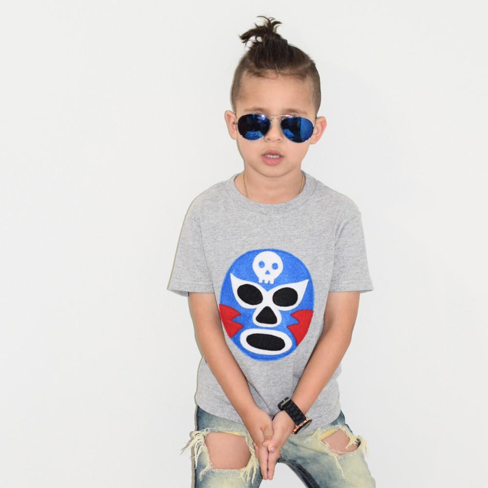 Vibrant Luchador Azul Kids T-shirt featuring colorful appliqué design, perfect for adventures.