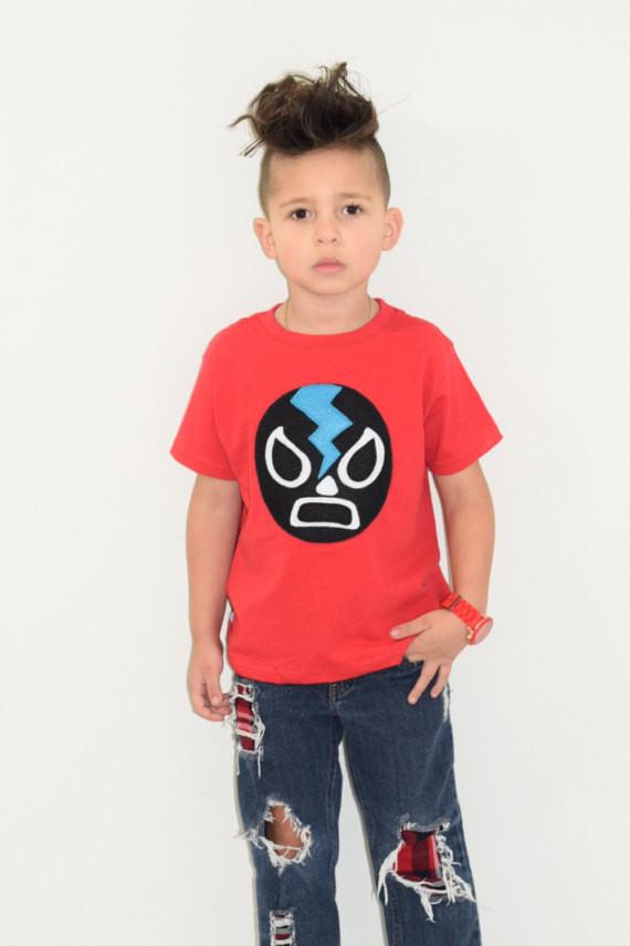 Kids T-shirt featuring a black Mexican wrestler design, perfect for young wrestling fans.