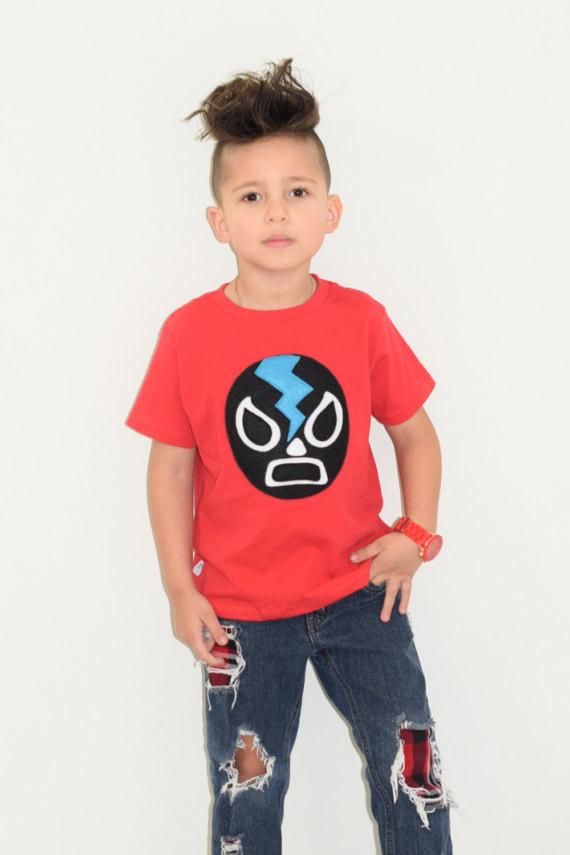 Kids T-shirt featuring a black Mexican wrestler design, perfect for young wrestling fans.