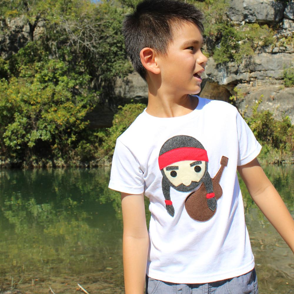 A colorful kids T-shirt featuring Willie the Music Man playing guitar, made with eco-friendly felt appliqué.