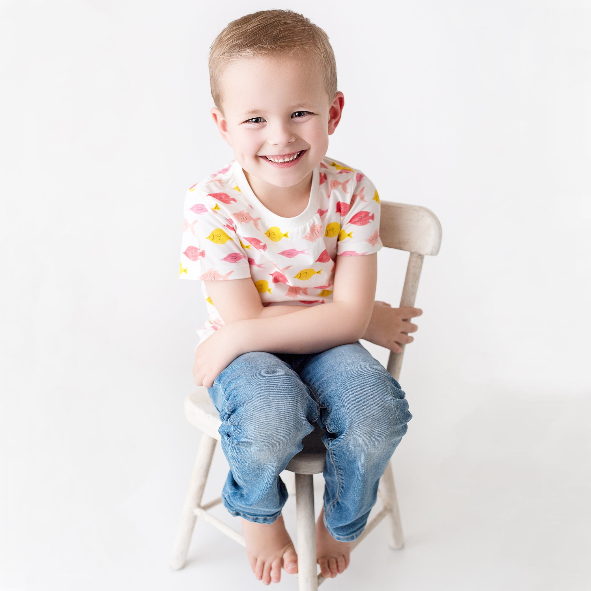 Kinsey tee in fishes print, featuring short sleeves and contrast color binding, made from stretchy cotton for kids aged 2T to 6T.