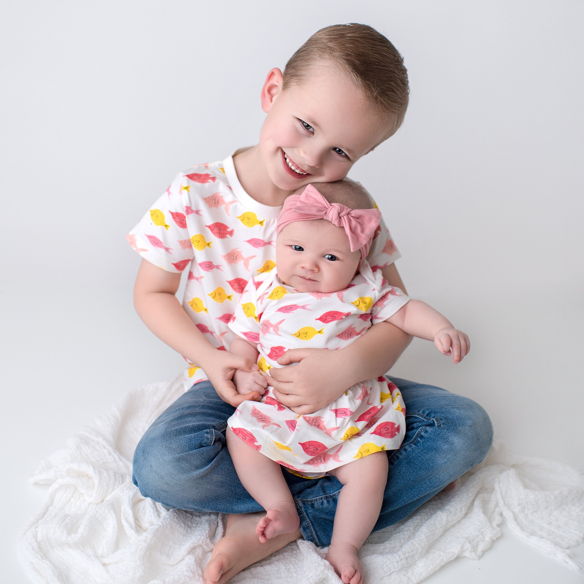 Kinsey tee in fishes print, featuring short sleeves and contrast color binding, made from stretchy cotton for kids aged 2T to 6T.