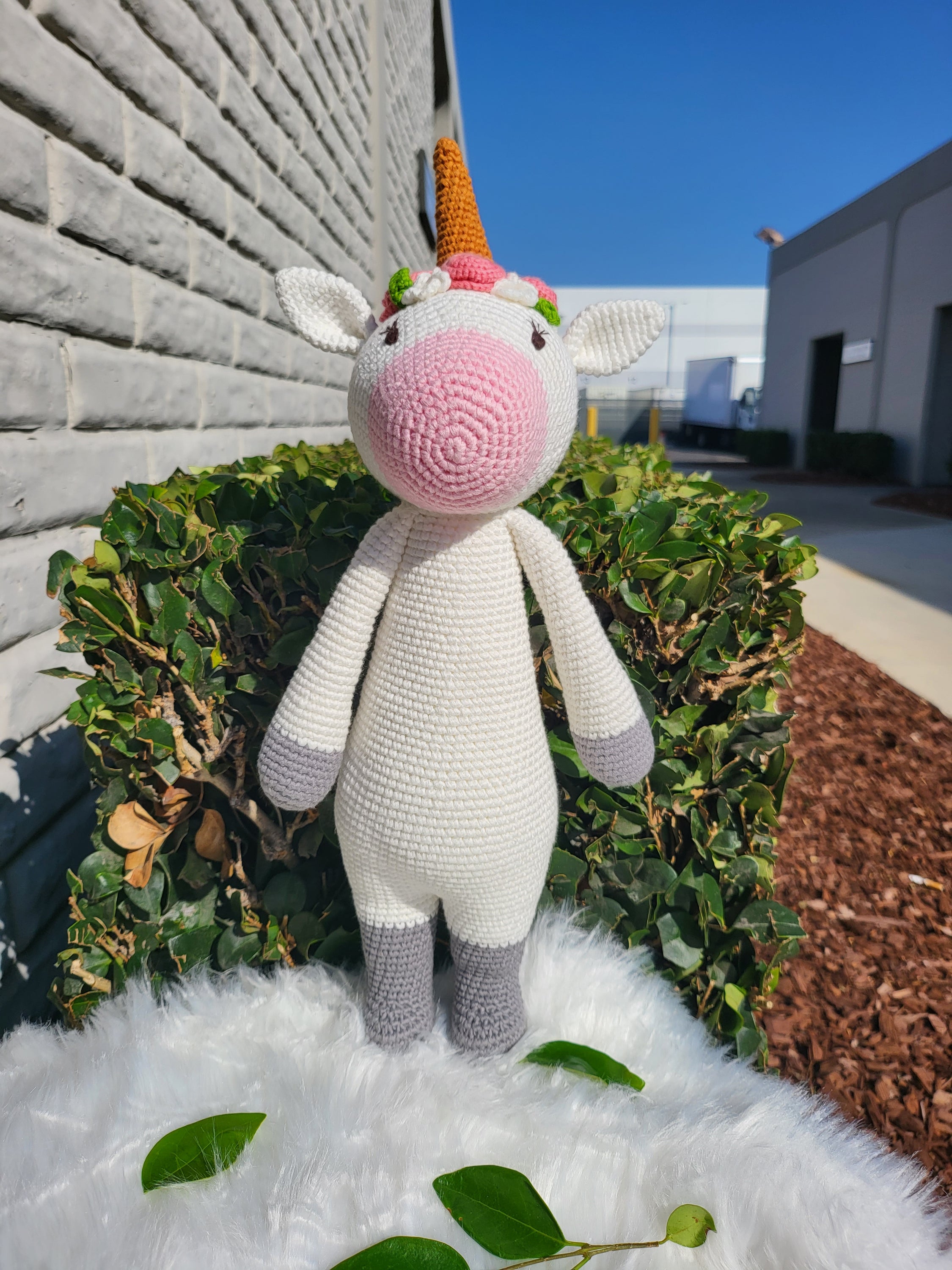 A large standing unicorn crochet toy made from 100% cotton yarn, featuring a colorful mane and tail, perfect for children and collectors.