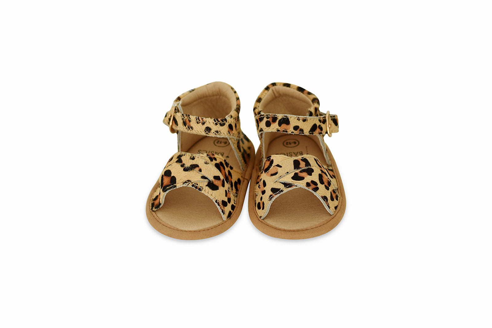 A pair of stylish leopard print baby sandals made of soft leather, featuring rubber treads for safety and comfort.