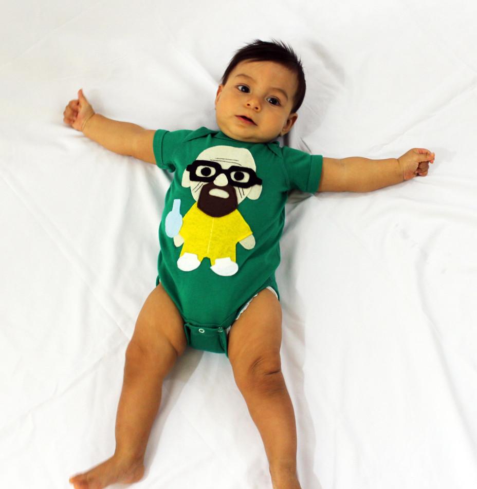 A playful green onesie featuring a character holding a flask, perfect for little chefs.