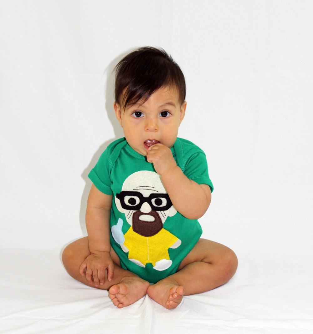 A playful green onesie featuring a character holding a flask, perfect for little chefs.