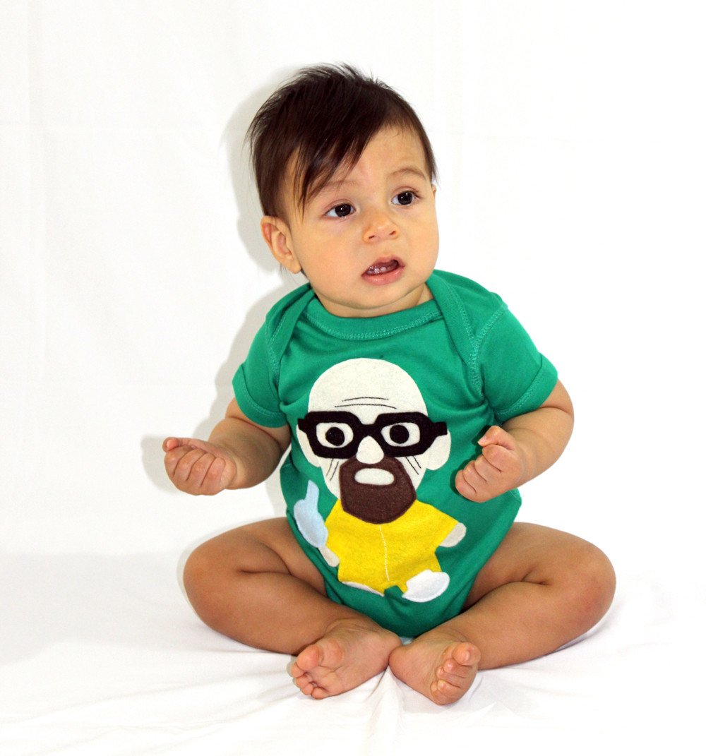 A playful green onesie featuring a character holding a flask, perfect for little chefs.