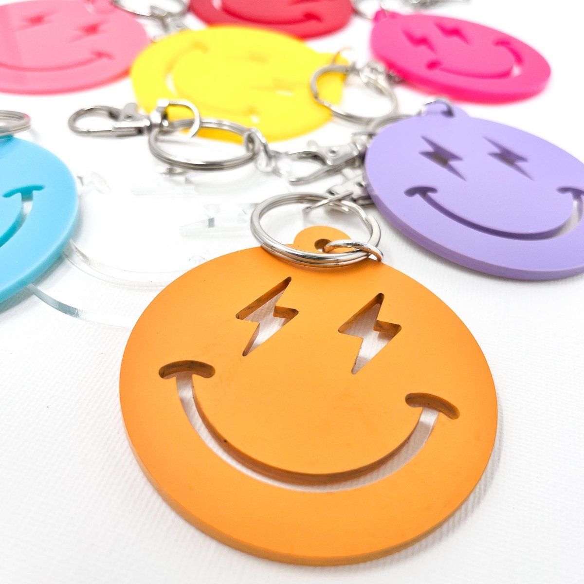 Colorful Lightning Smiley Face Keychain made of acrylic, featuring a cheerful smiley face design, perfect for everyday use.