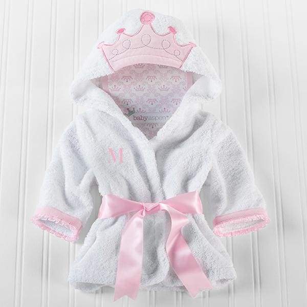 A soft white hooded spa robe for infants featuring a princess crown applique and organza-trimmed sleeves, tied with a pink satin ribbon.