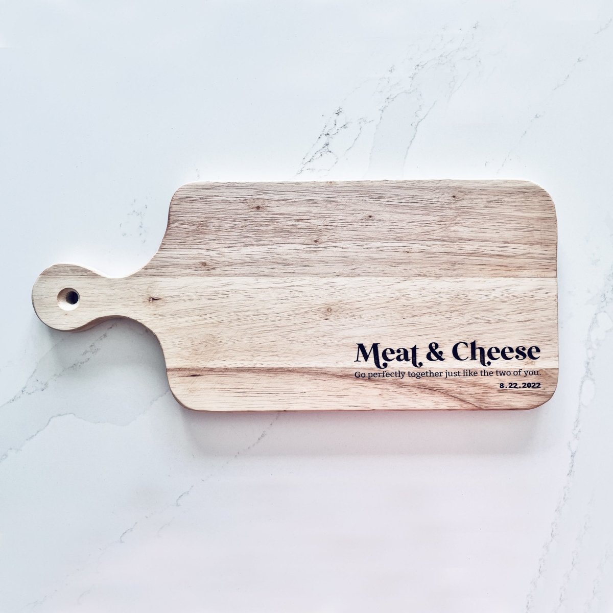 A beautifully crafted Meat & Cheese Charcuterie Board featuring a rustic wood grain finish, perfect for serving assorted meats and cheeses.