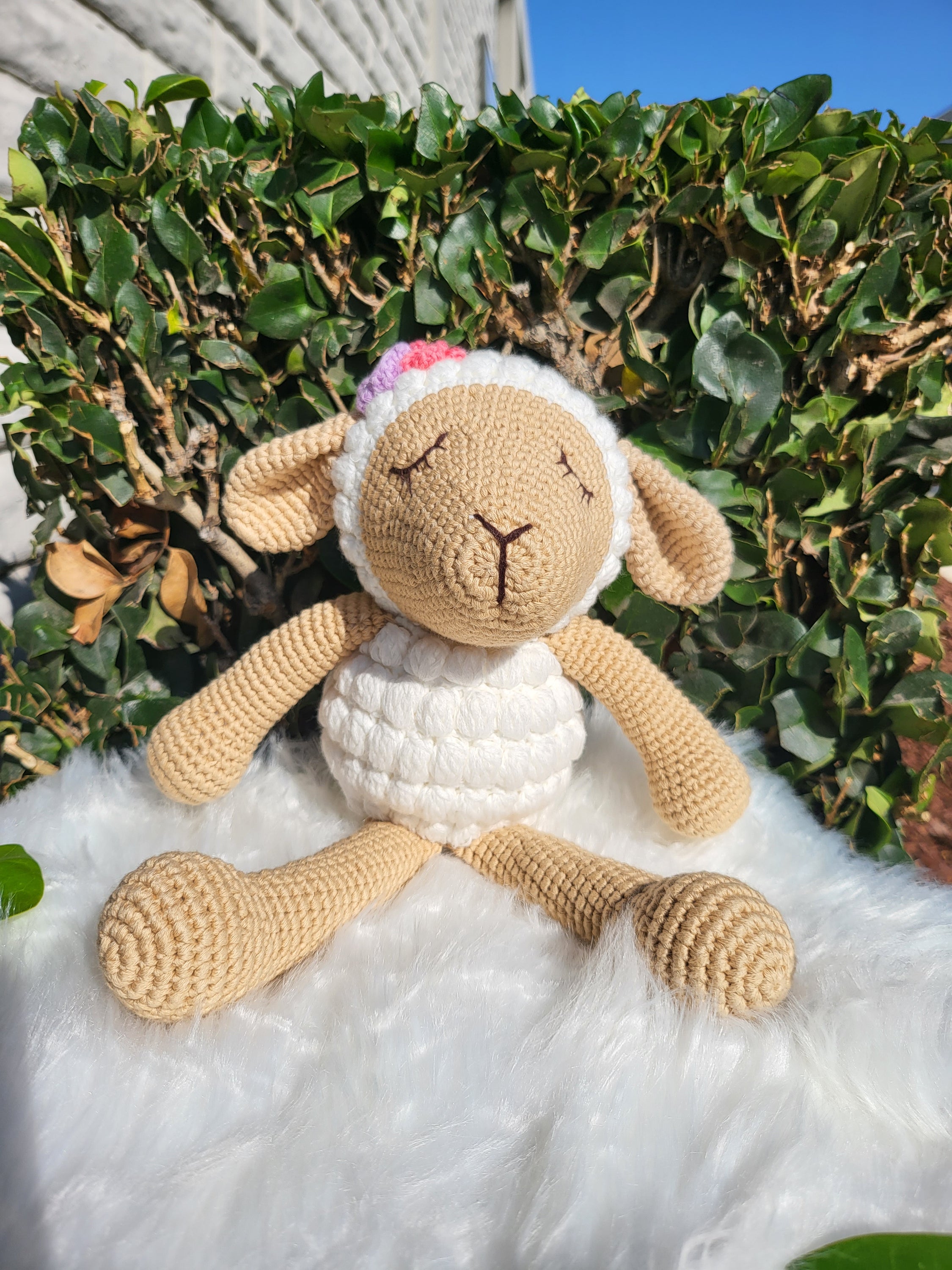 A charming medium-sized sitting sheep crochet toy made from 100% cotton yarn, featuring a soft texture and unique handmade design.