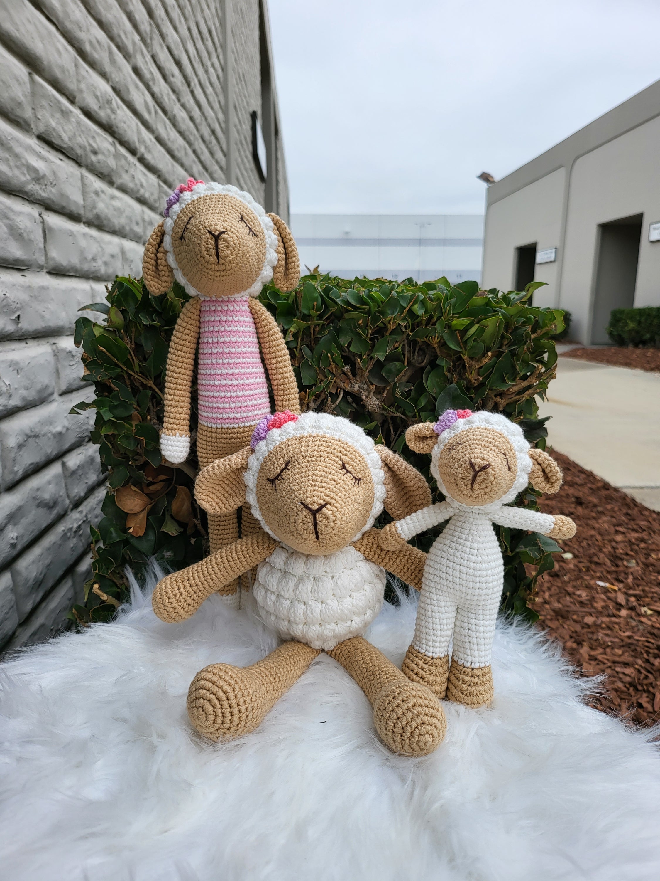 A charming medium-sized sitting sheep crochet toy made from 100% cotton yarn, featuring a soft texture and unique handmade design.