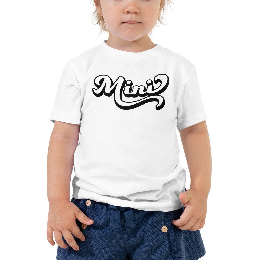 A cute toddler wearing a retro Mini Shirt made of soft cotton, perfect for family photos.