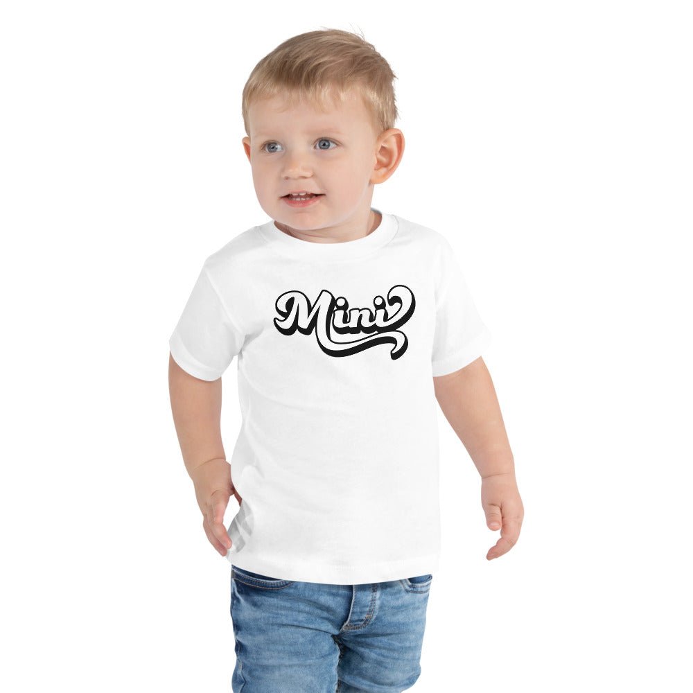 A cute toddler wearing a retro Mini Shirt made of soft cotton, perfect for family photos.