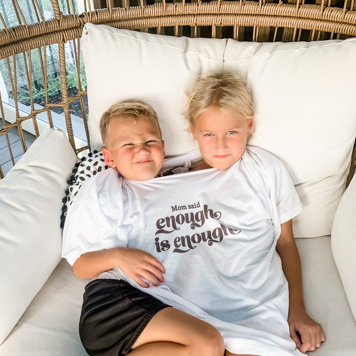 Kids wearing the 'Mom said... enough is enough' shirt, promoting sibling harmony and fun.