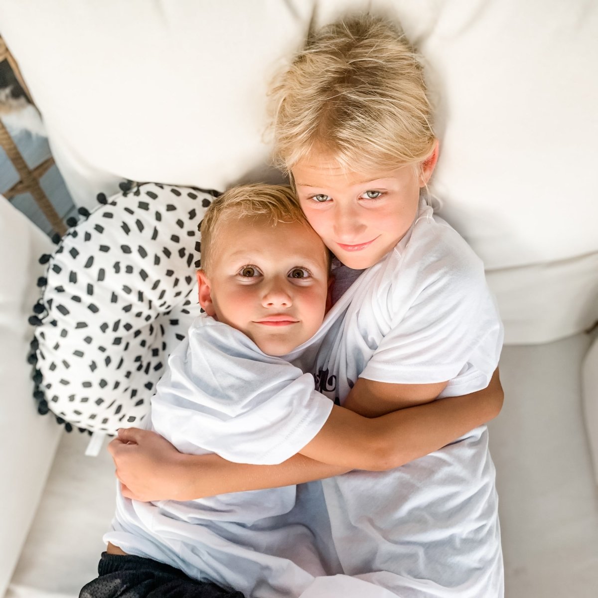 Kids wearing the 'Mom said... enough is enough' shirt, promoting sibling harmony and fun.