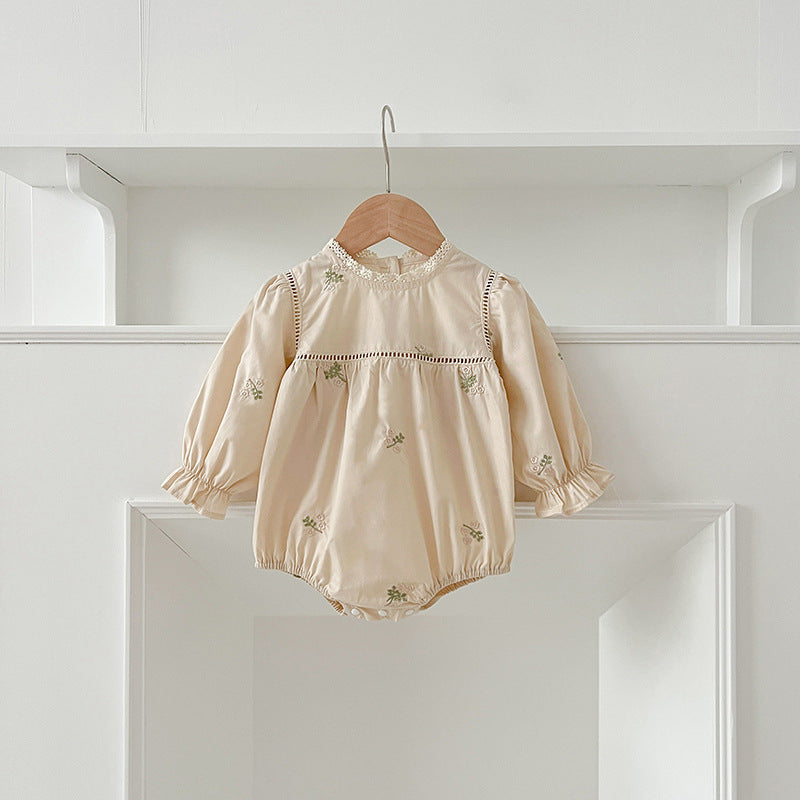 A beautiful baby girls dress featuring floral embroidery and lace trim, available in beige and apricot colors.