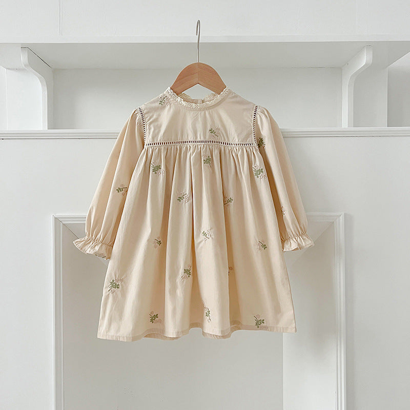 A beautiful baby girls dress featuring floral embroidery and lace trim, available in beige and apricot colors.