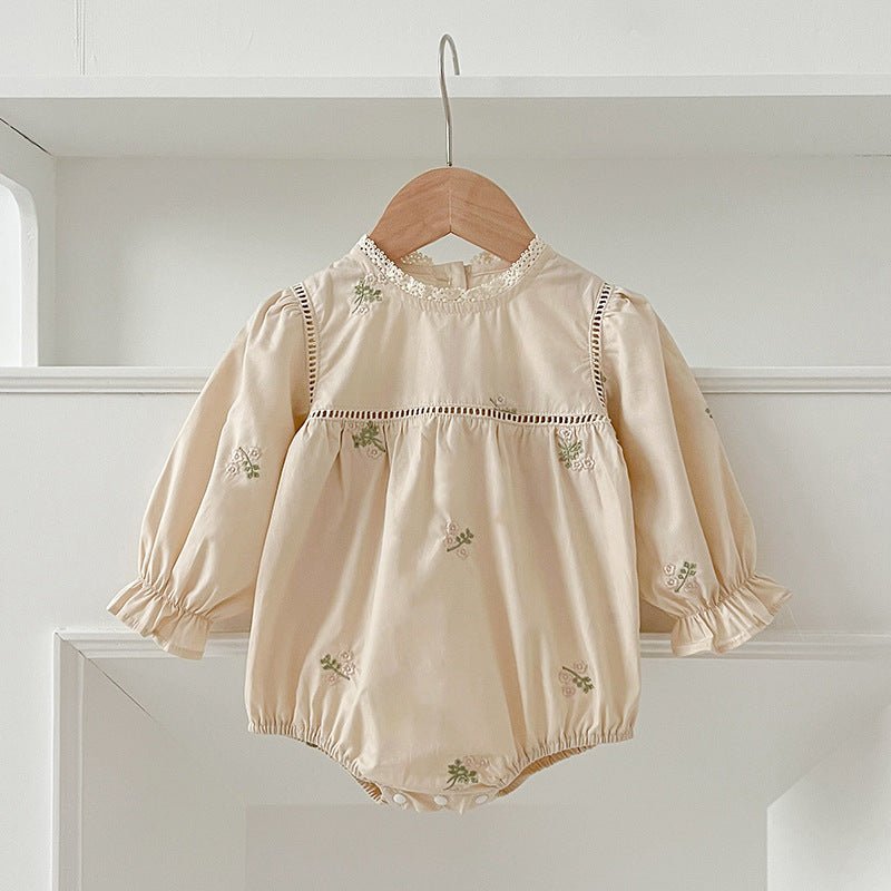 A beautiful baby girls dress featuring floral embroidery and lace trim, available in beige and apricot colors.