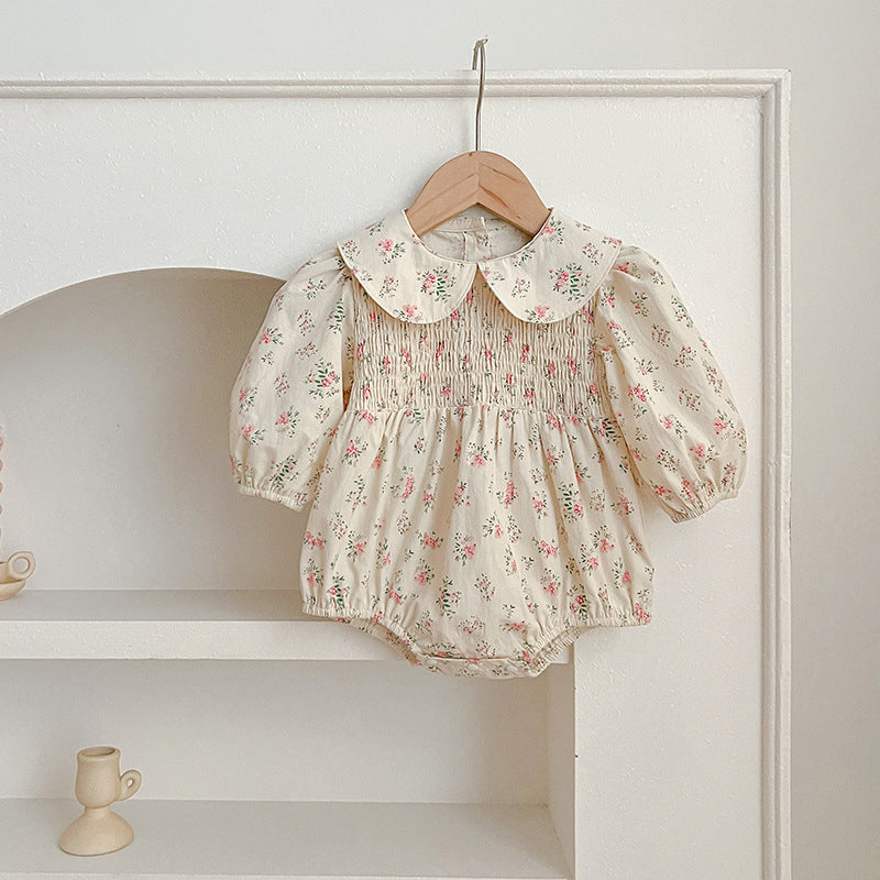 A pink floral print baby onesie with a Peter Pan collar, perfect for autumn wear, showcasing its soft fabric and charming design.