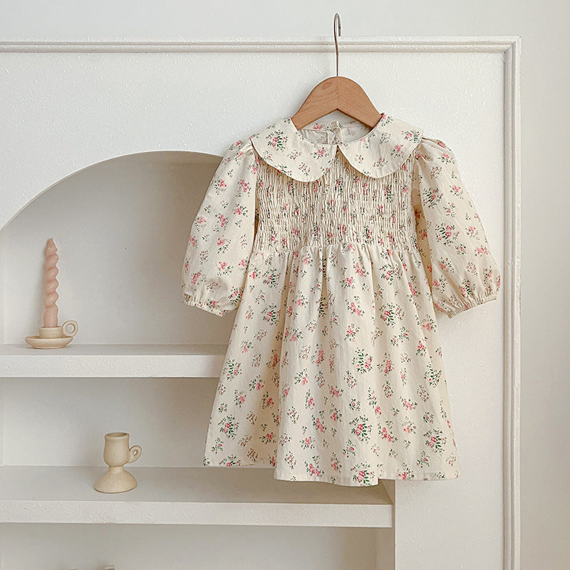 A pink floral print baby onesie with a Peter Pan collar, perfect for autumn wear, showcasing its soft fabric and charming design.