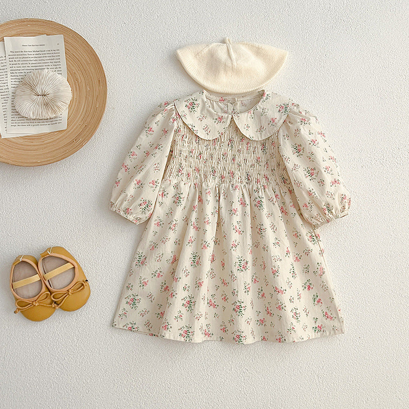 A pink floral print baby onesie with a Peter Pan collar, perfect for autumn wear, showcasing its soft fabric and charming design.