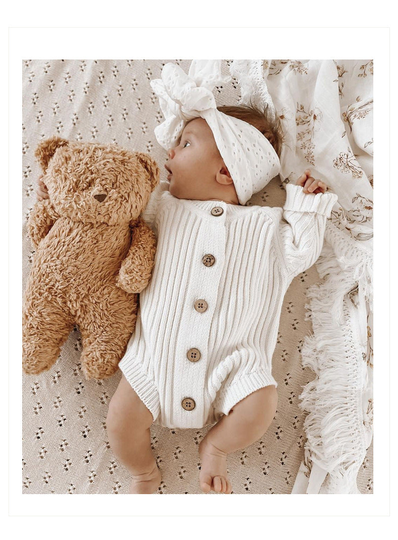 A cozy baby onesie made of soft cotton, available in white and brown, perfect for infants aged 0-24 months.