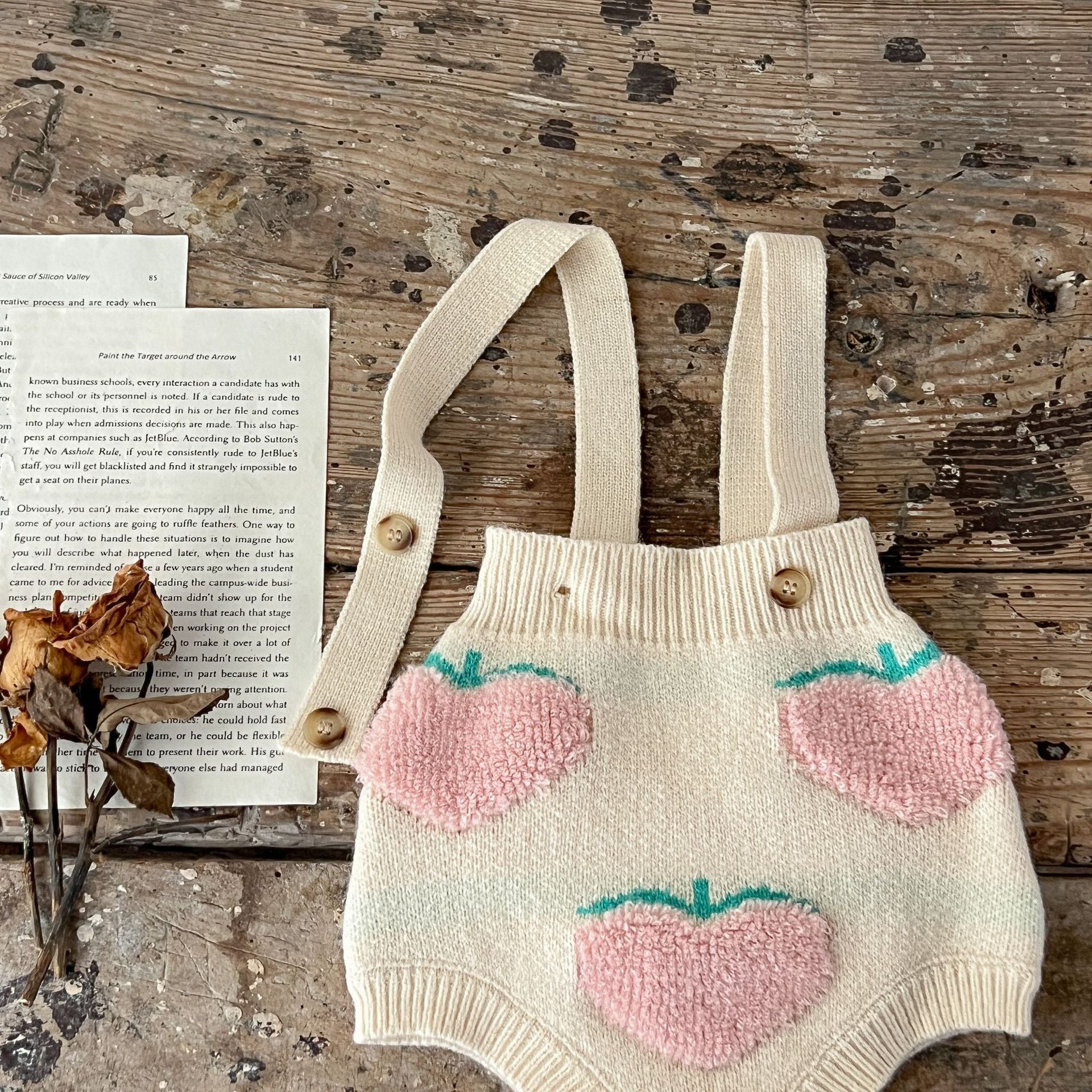 Baby girl wearing a beige cardigan combo with peach embroidery, showcasing a stylish and comfortable outfit for infants.