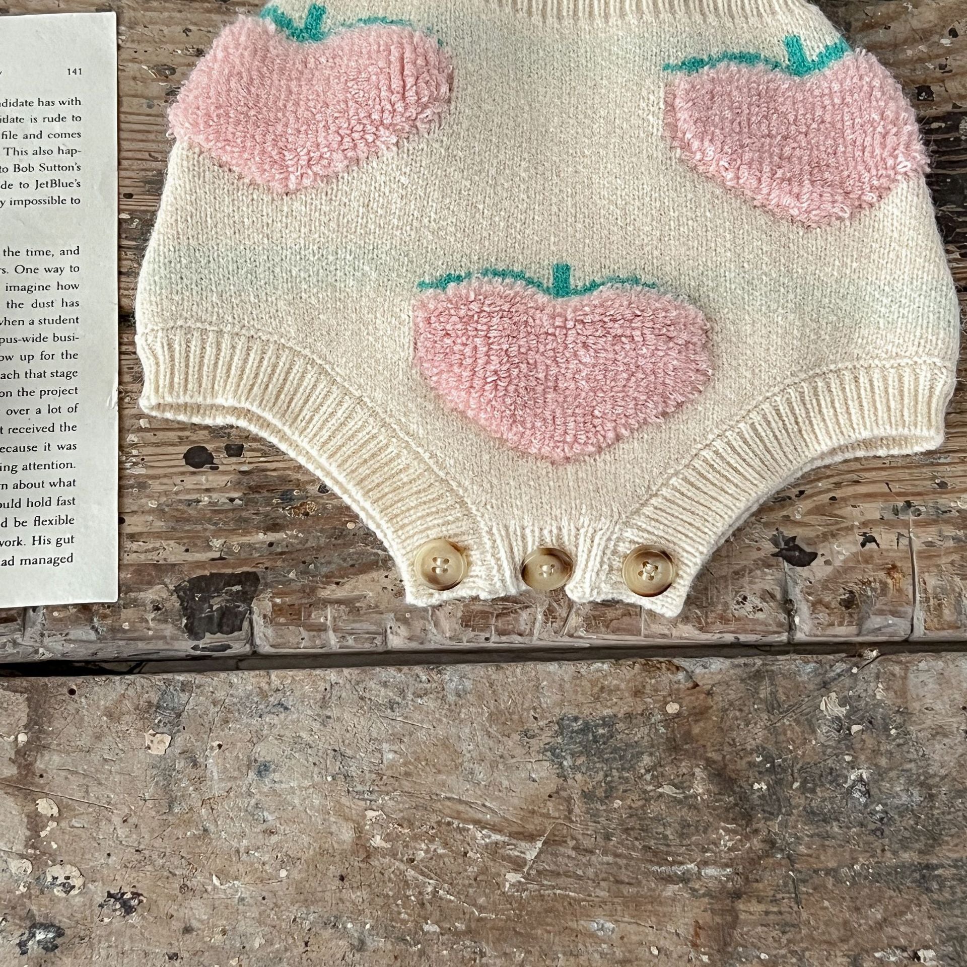 Baby girl wearing a beige cardigan combo with peach embroidery, showcasing a stylish and comfortable outfit for infants.