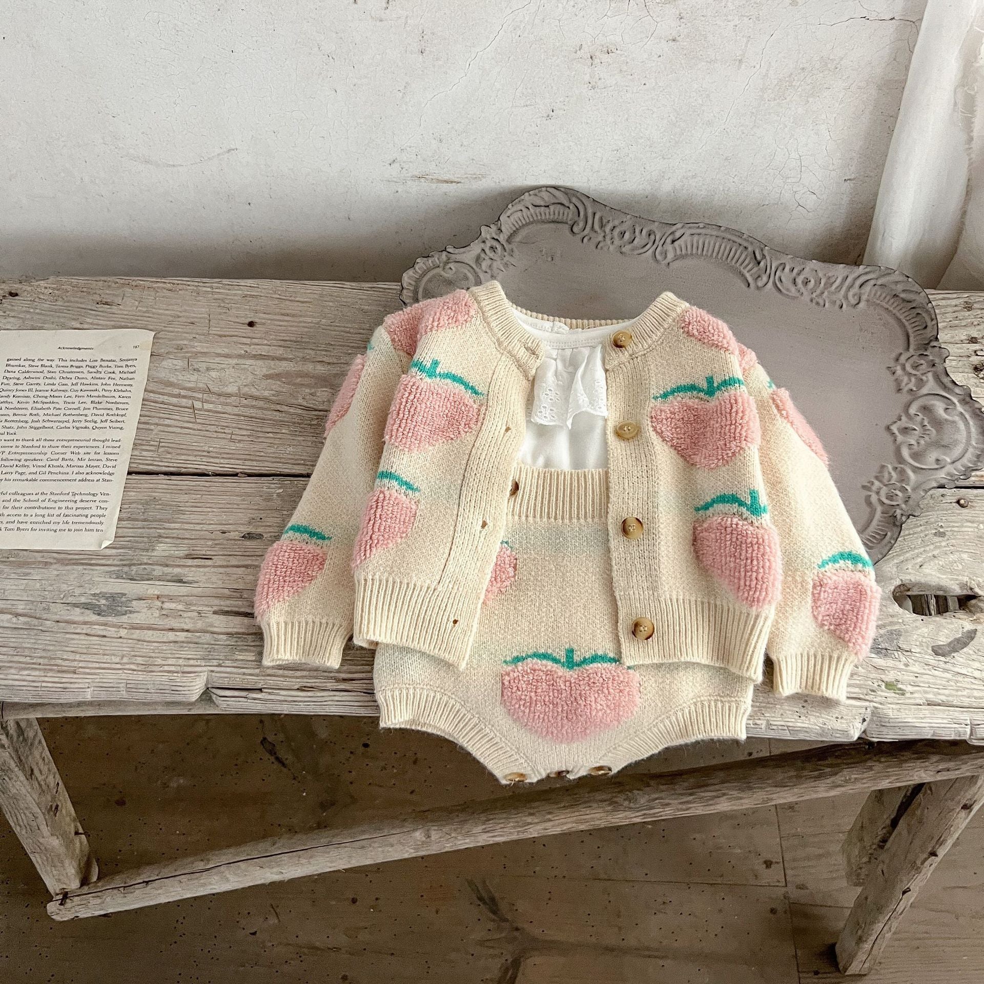 Baby girl wearing a beige cardigan combo with peach embroidery, showcasing a stylish and comfortable outfit for infants.