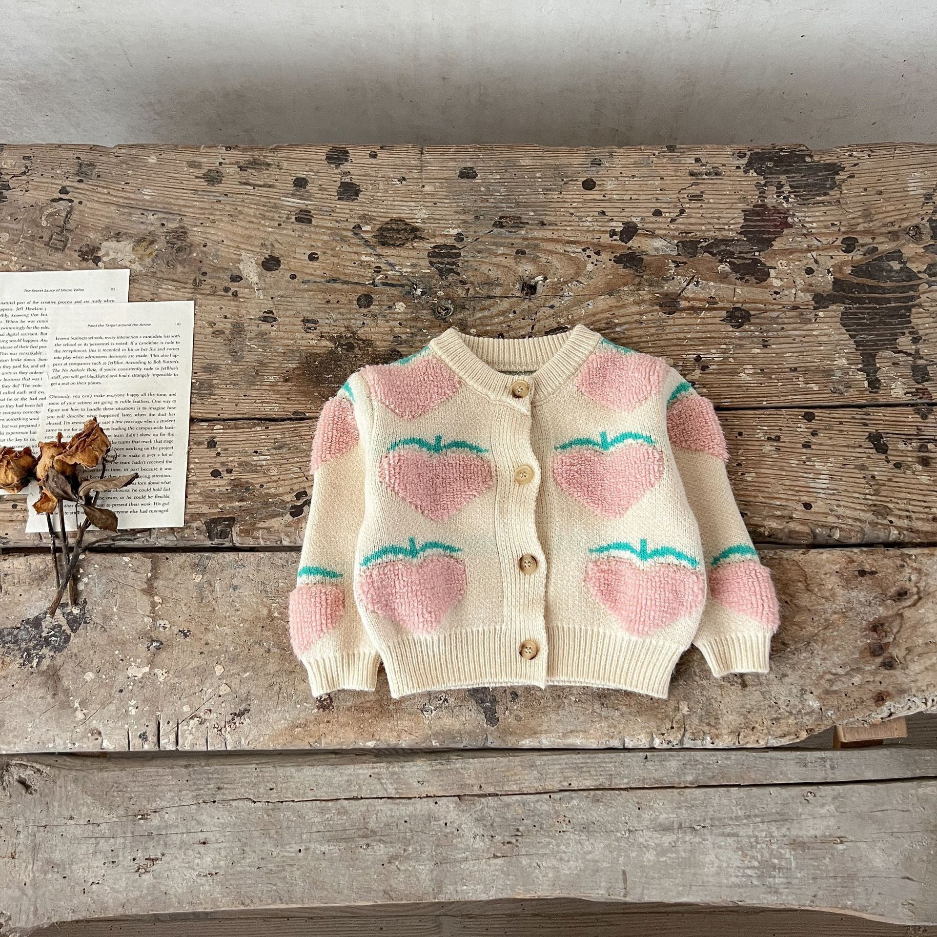 Baby girl wearing a beige cardigan combo with peach embroidery, showcasing a stylish and comfortable outfit for infants.