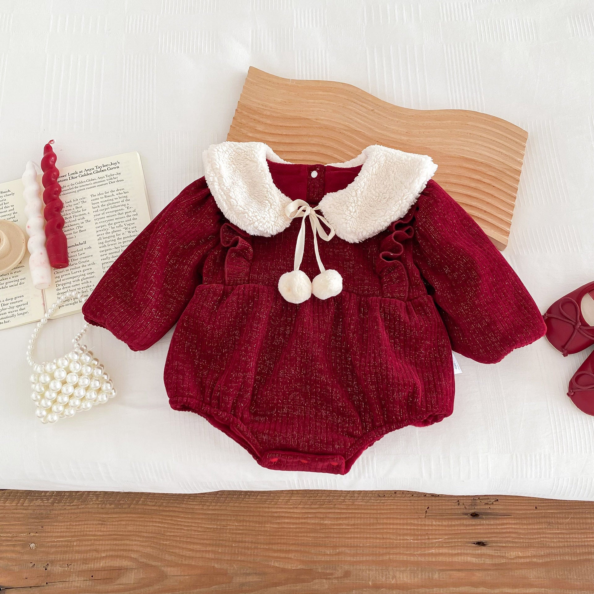 A vibrant red long-sleeve top for baby girls featuring ruffles, made from a soft cotton and polyester blend, perfect for cooler weather.