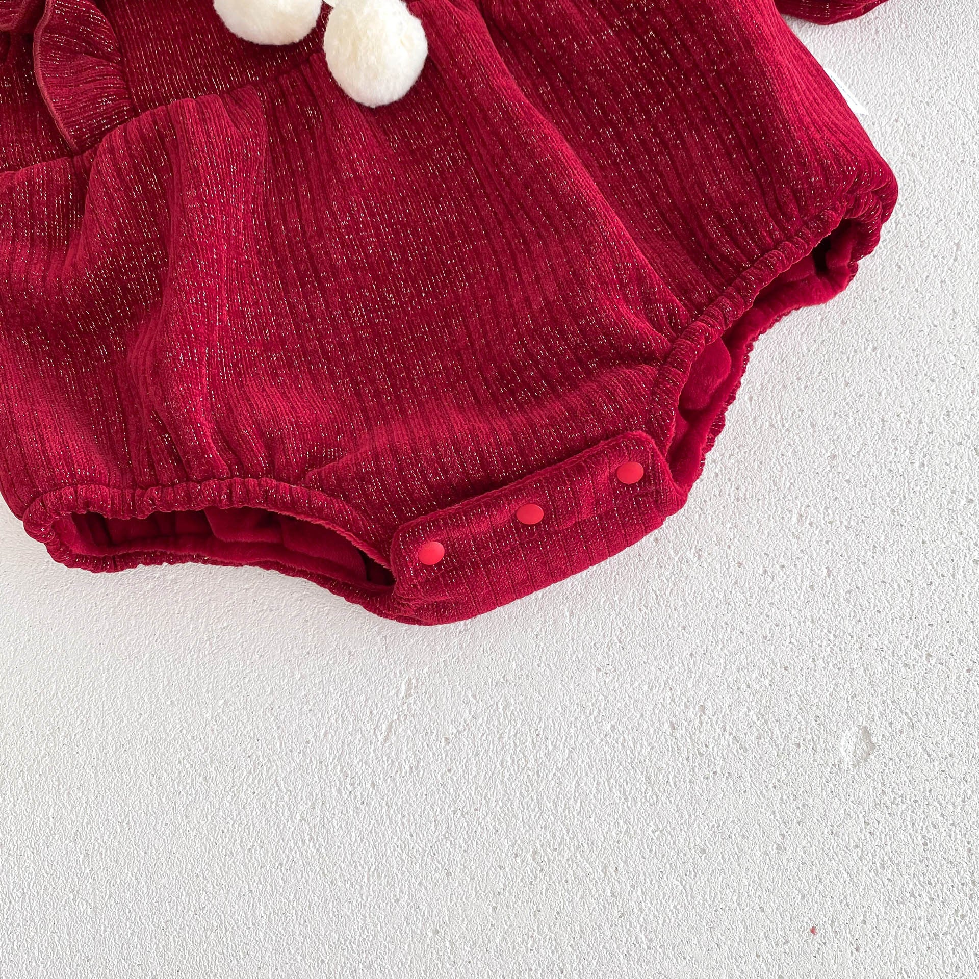 A vibrant red long-sleeve top for baby girls featuring ruffles, made from a soft cotton and polyester blend, perfect for cooler weather.