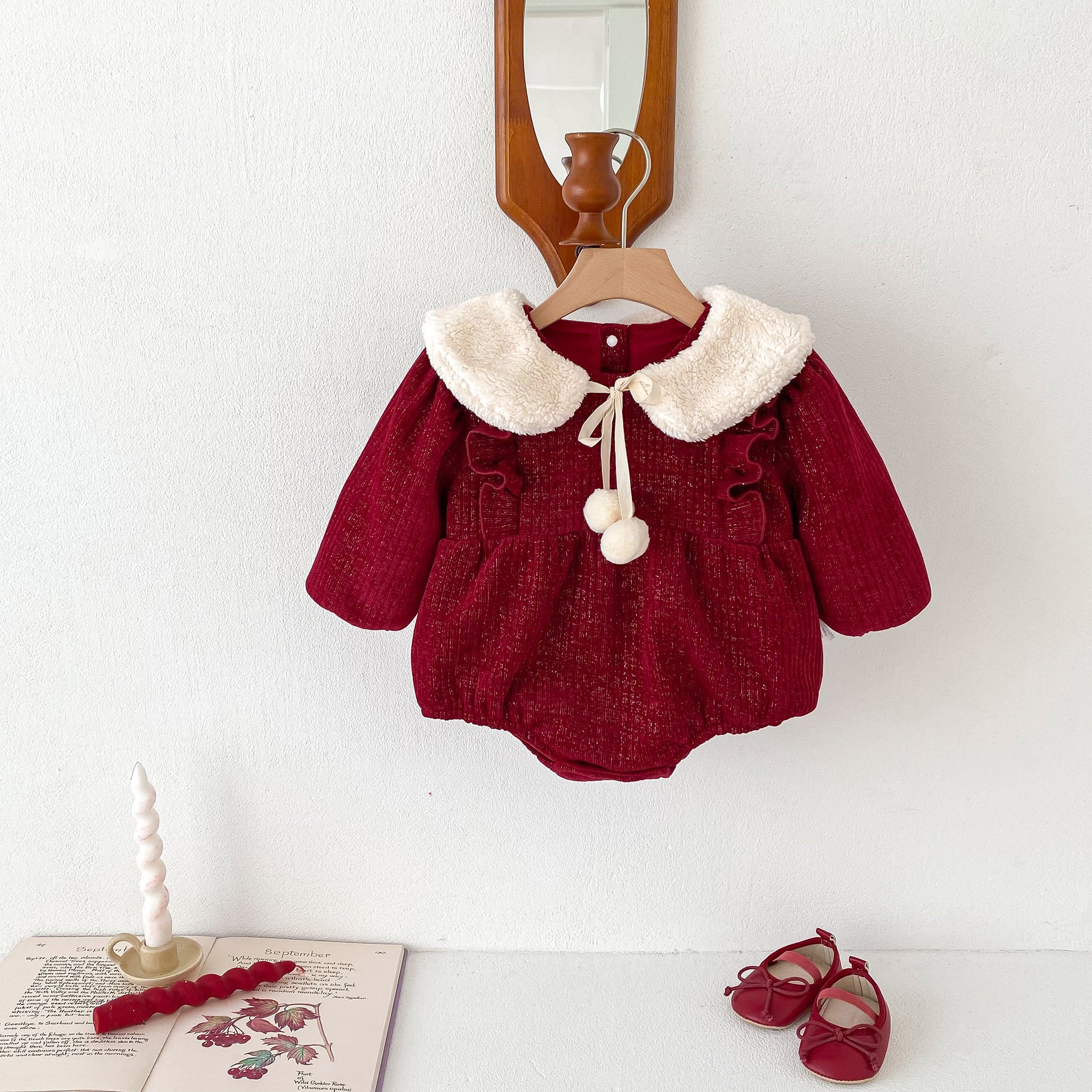 A vibrant red long-sleeve top for baby girls featuring ruffles, made from a soft cotton and polyester blend, perfect for cooler weather.